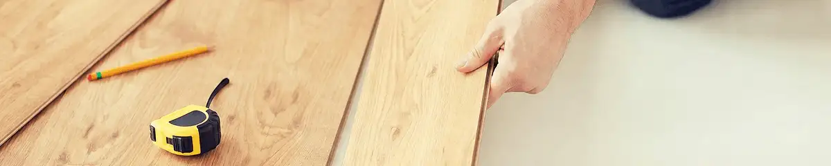 A professional installing wood flooring in Birmingham, AL
