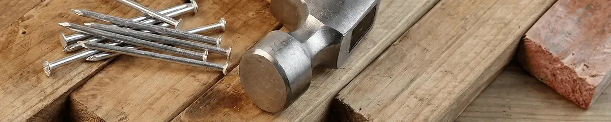 Hammer and nails on hardwood flooring boards in Birmingham, AL