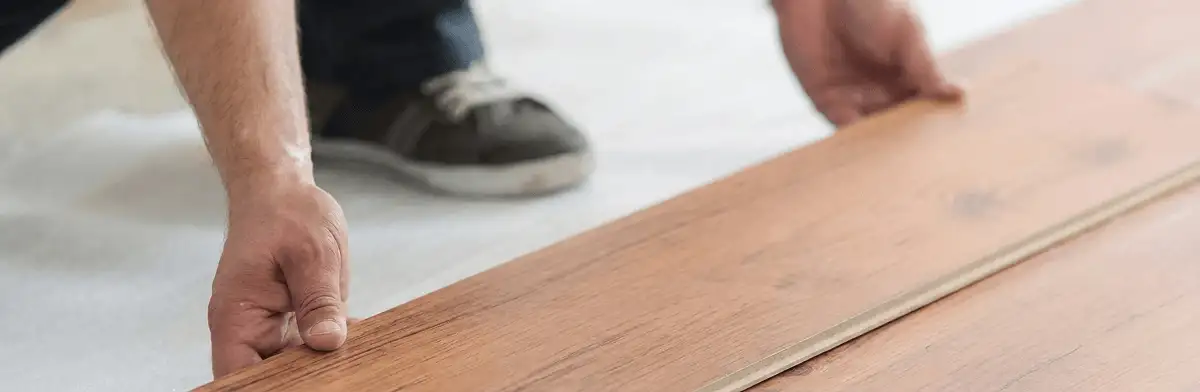A professional installing laminate flooring in Birmingham, AL
