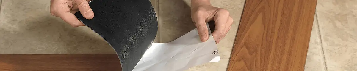 A professional installing vinyl flooring in Birmingham, AL
