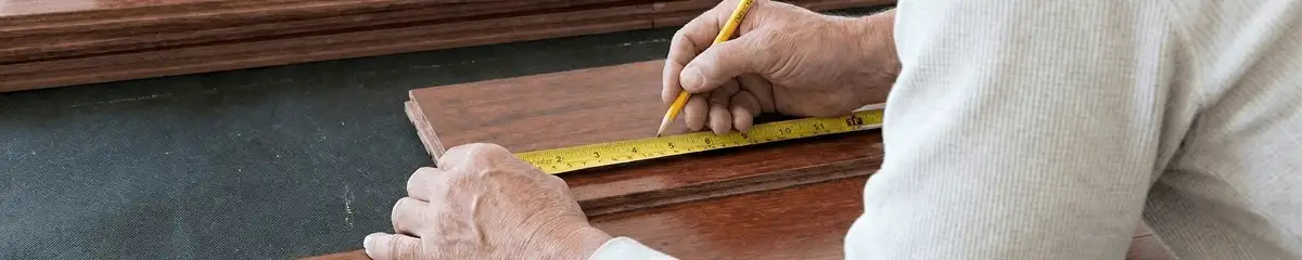A professional installing wood flooring in Birmingham, AL